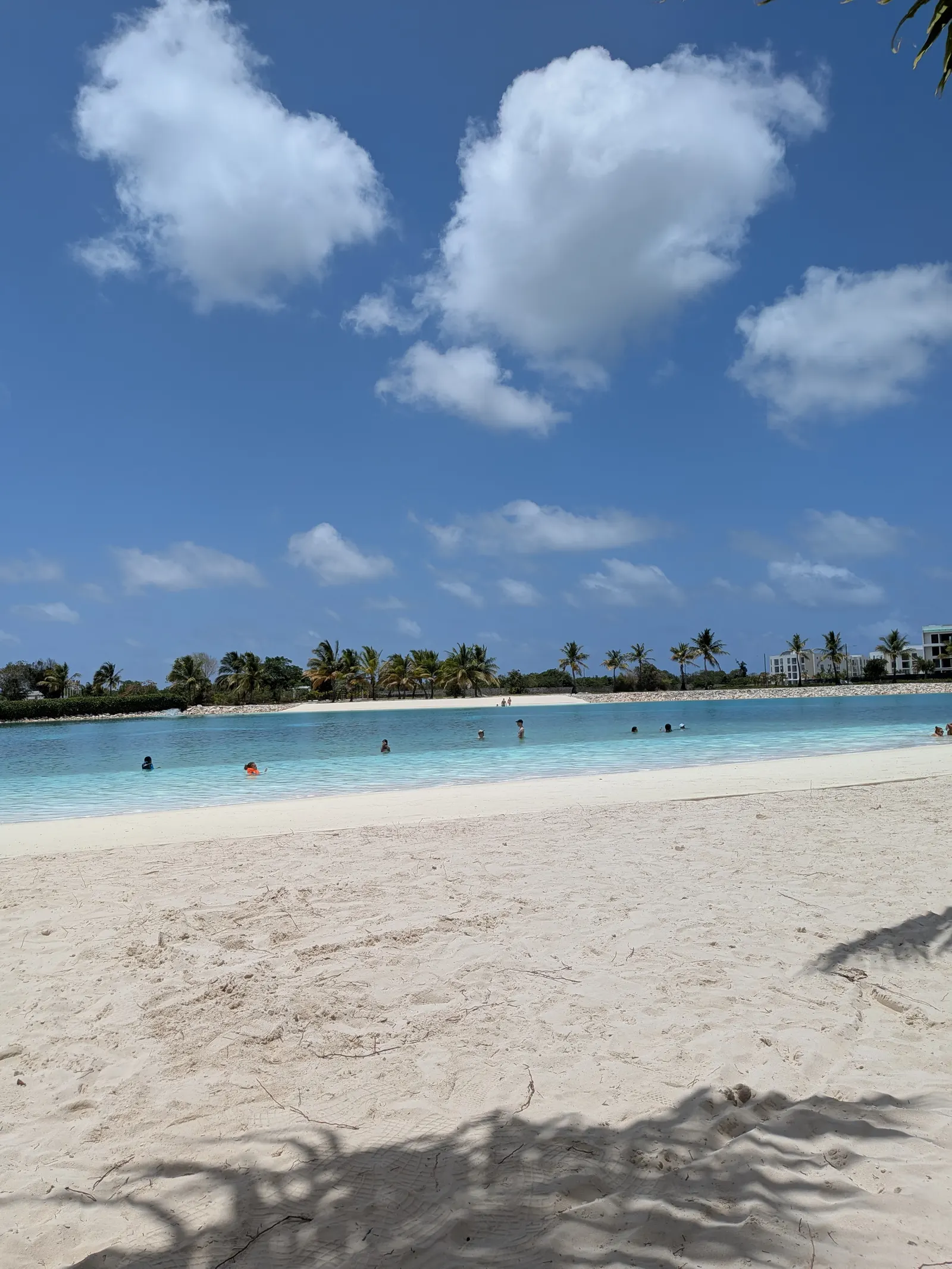 The lagoon-style beach in the Vistacana community, with white sand and turquoise water