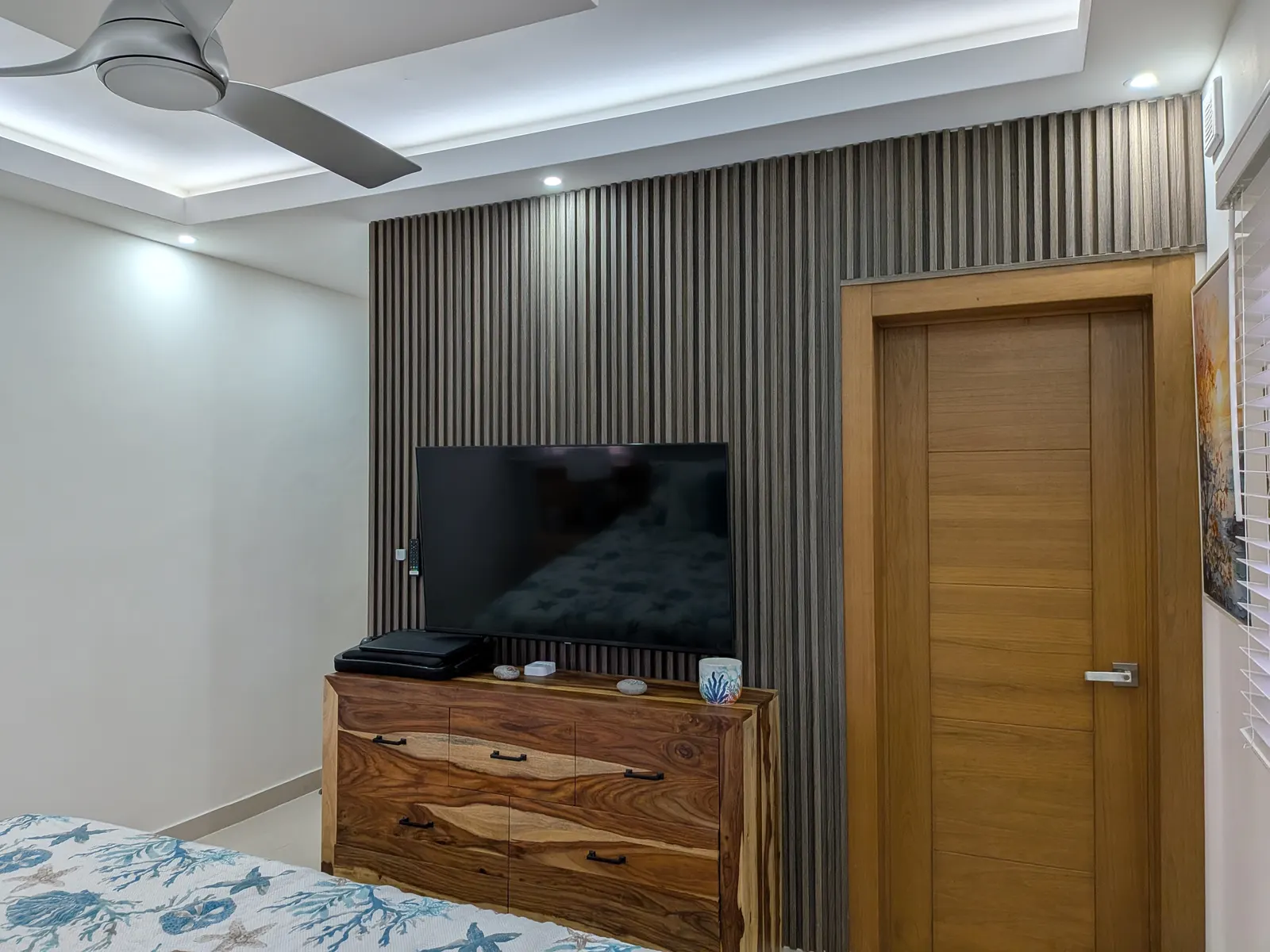 The master bedroom TV wall and live-edge dresser