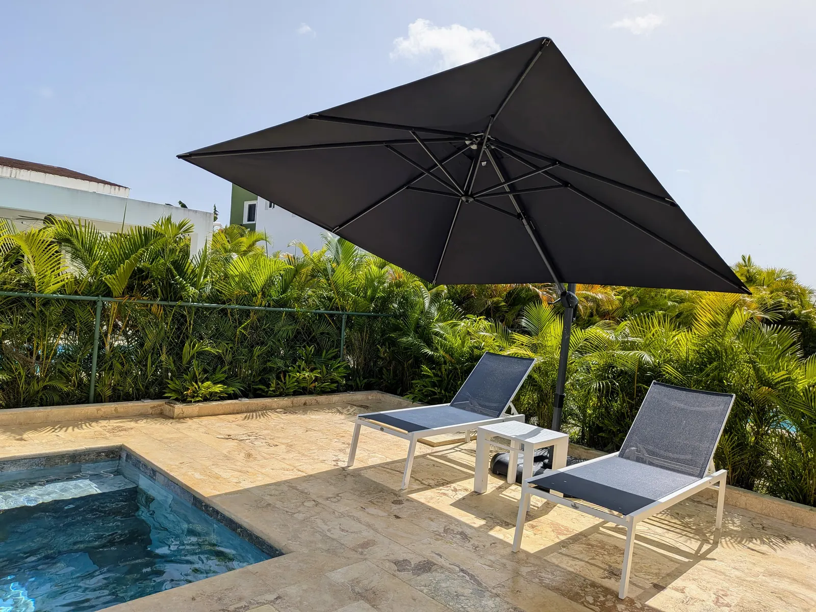 A wide view of the pool and backyard